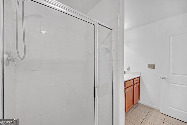 bathroom featuring vanity, tile patterned floors, and walk in shower