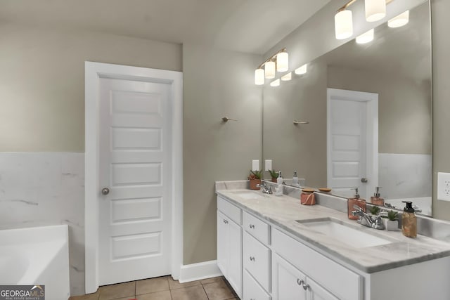 bathroom featuring tile patterned flooring, vanity, and a tub to relax in