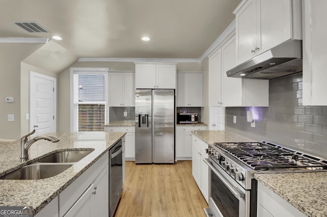 kitchen featuring white cabinetry, sink, light hardwood / wood-style floors, stainless steel appliances, and light stone countertops