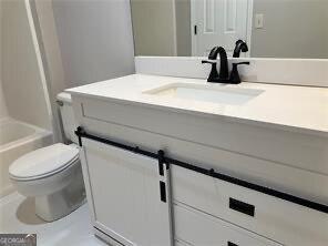 bathroom featuring vanity and toilet