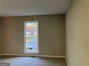 unfurnished room featuring carpet floors