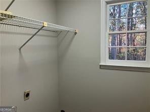 laundry room featuring electric dryer hookup and plenty of natural light