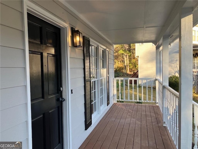 wooden terrace featuring covered porch