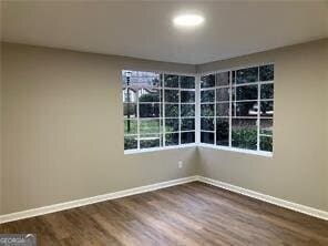 unfurnished room with wood-type flooring and plenty of natural light