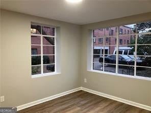 spare room with dark hardwood / wood-style flooring