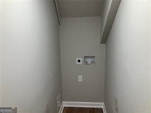 laundry area featuring dark wood-type flooring, washer hookup, and electric dryer hookup