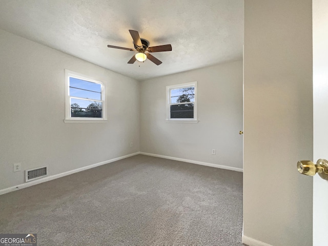 empty room featuring ceiling fan and carpet flooring