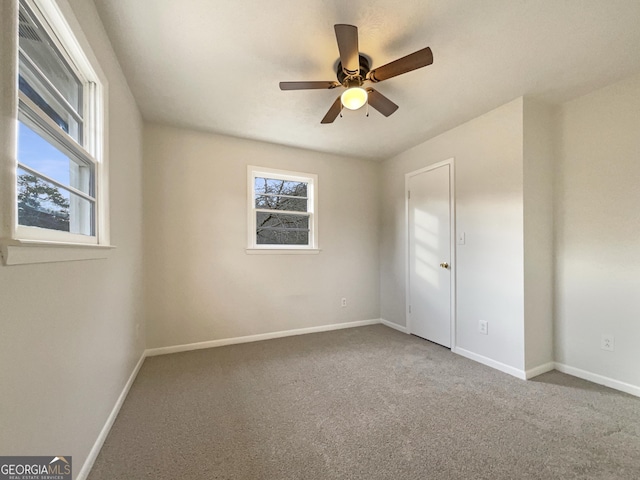 empty room featuring ceiling fan and carpet flooring