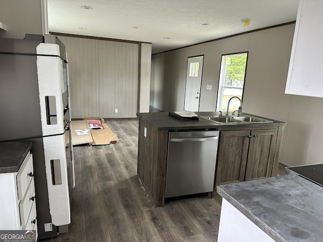 kitchen featuring sink, ornamental molding, fridge, stainless steel dishwasher, and dark wood-type flooring