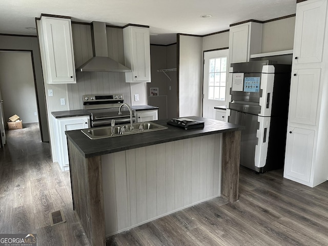 kitchen featuring an island with sink, white cabinets, dark hardwood / wood-style flooring, fridge, and wall chimney exhaust hood