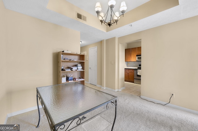 carpeted dining area with an inviting chandelier