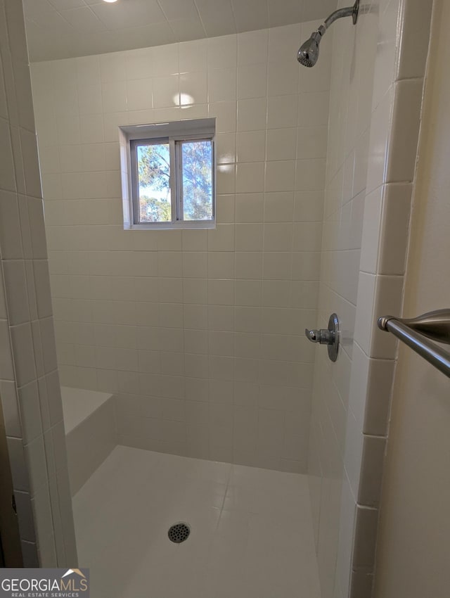 bathroom with a tile shower