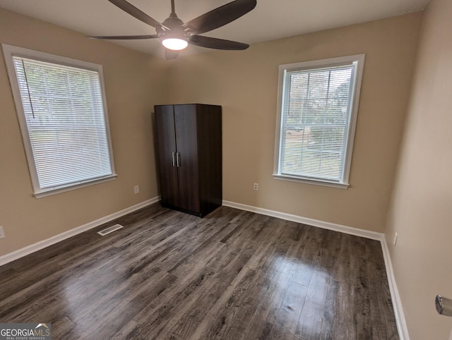 unfurnished room featuring ceiling fan and dark hardwood / wood-style floors