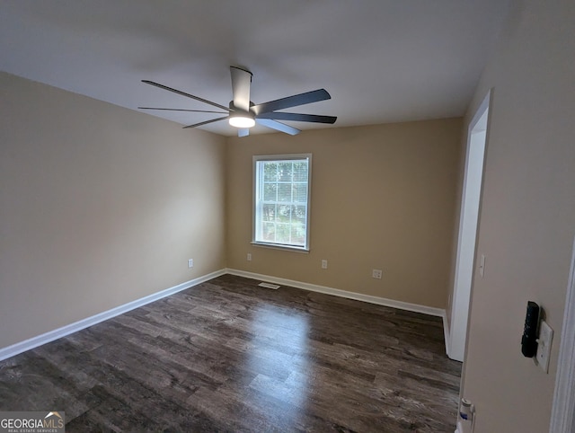 spare room with ceiling fan and dark hardwood / wood-style flooring