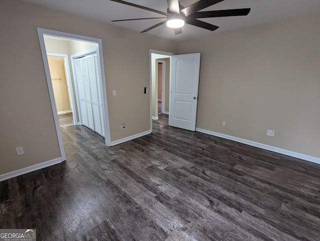 unfurnished bedroom with ceiling fan, dark hardwood / wood-style flooring, and a closet