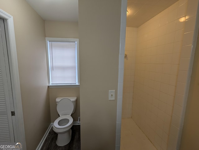 bathroom with hardwood / wood-style flooring and toilet