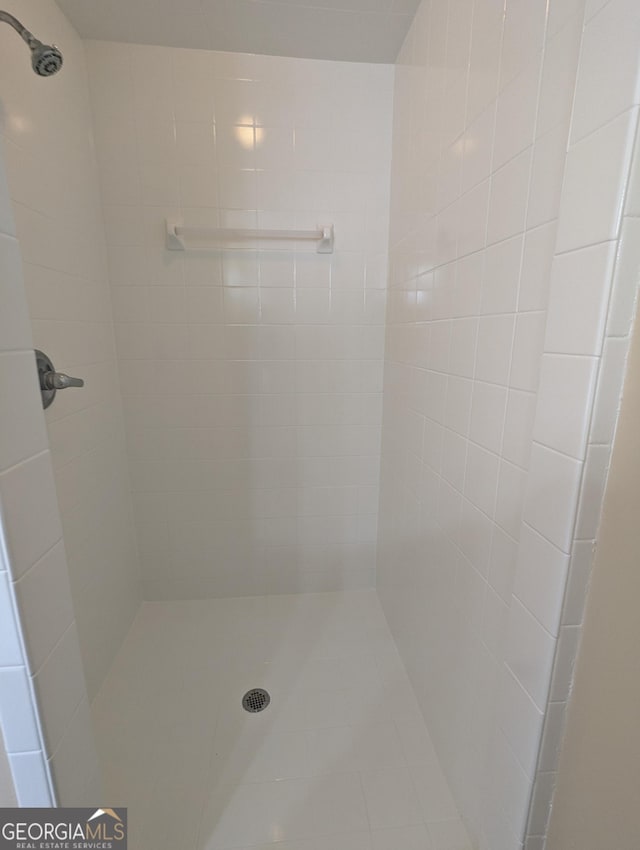 bathroom with tiled shower