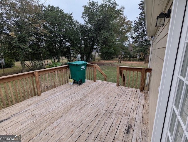 wooden terrace with a yard