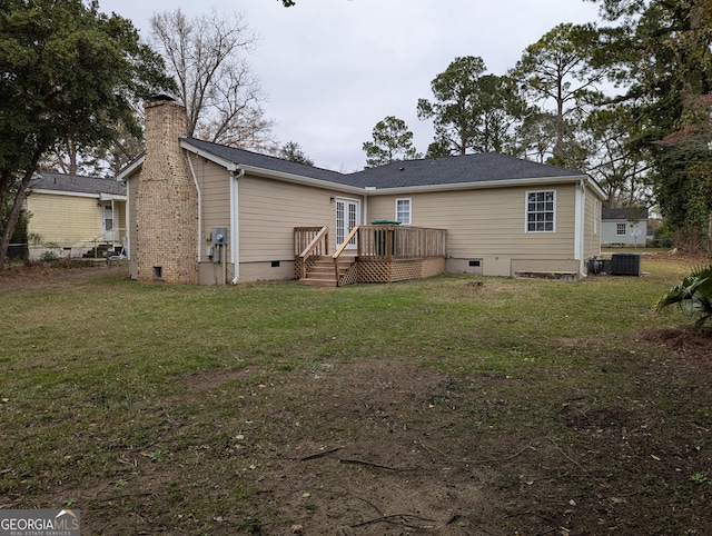 back of house featuring a wooden deck, a yard, and central air condition unit