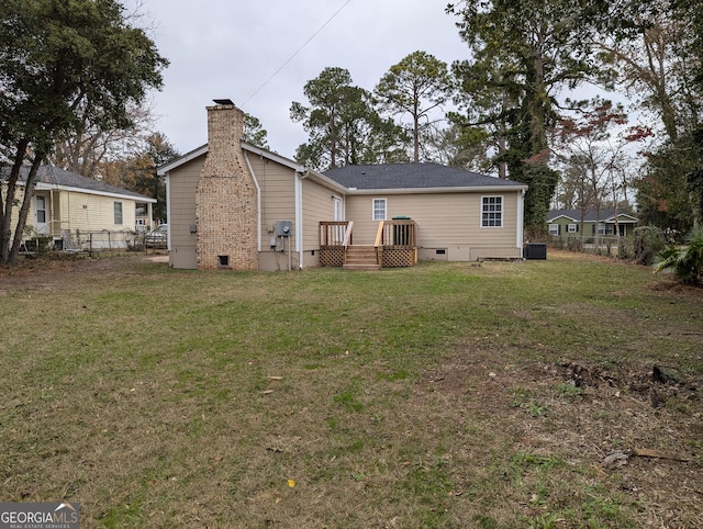 back of house featuring a yard