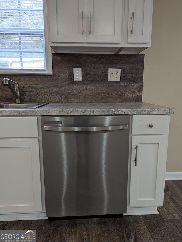 kitchen featuring tasteful backsplash, white cabinetry, dishwasher, sink, and dark hardwood / wood-style flooring