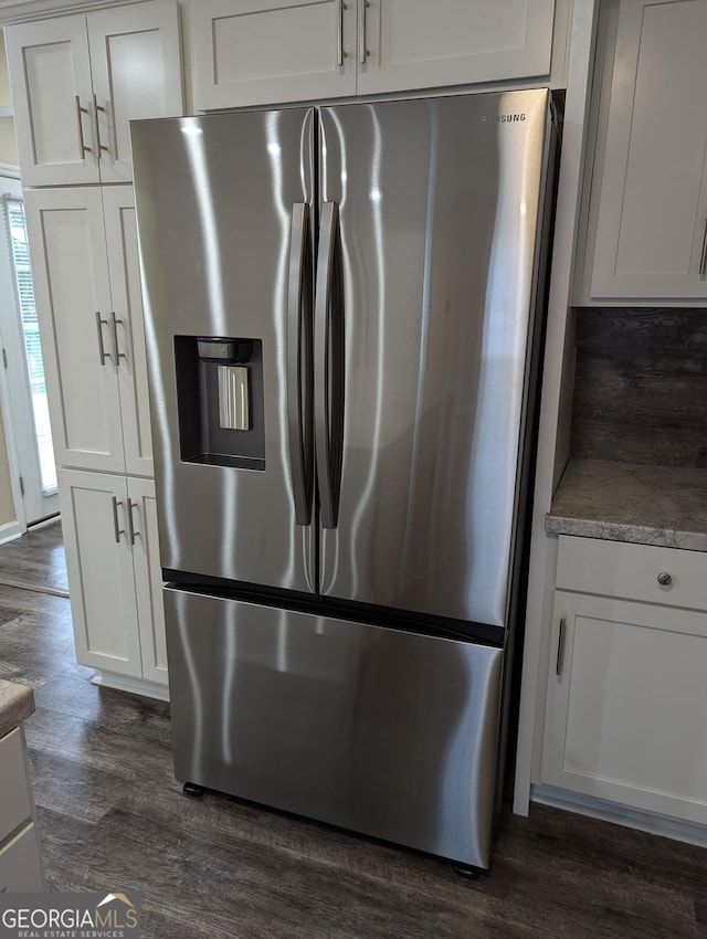 kitchen featuring stainless steel refrigerator with ice dispenser, white cabinetry, and dark wood-type flooring