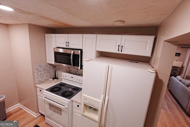 kitchen with white cabinetry, white appliances, tasteful backsplash, and light hardwood / wood-style flooring