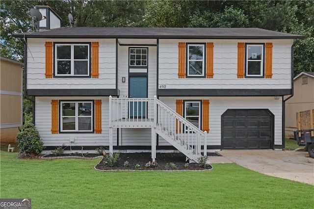 bi-level home featuring a garage and a front yard