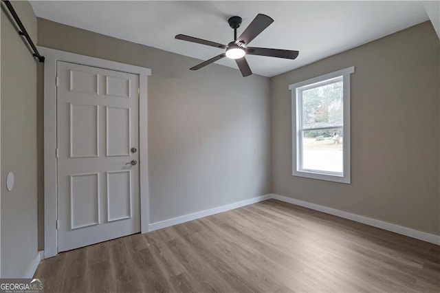 unfurnished room with light hardwood / wood-style floors and ceiling fan