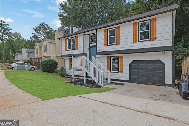 bi-level home with a garage and a front yard