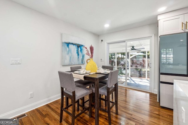 dining space featuring dark hardwood / wood-style floors and ceiling fan