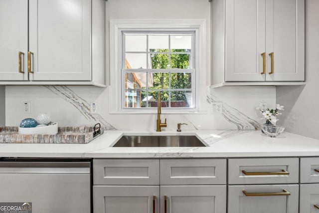 bar with gray cabinets, light stone countertops, and dishwasher