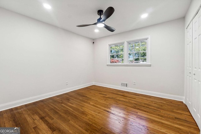 unfurnished bedroom with hardwood / wood-style floors, ceiling fan, and a closet