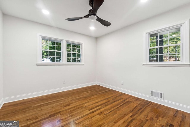 empty room with hardwood / wood-style flooring and ceiling fan