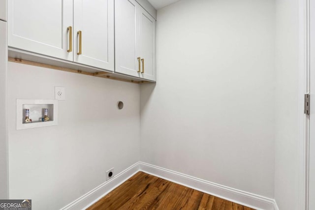 laundry area featuring cabinets, washer hookup, hookup for an electric dryer, and dark hardwood / wood-style flooring