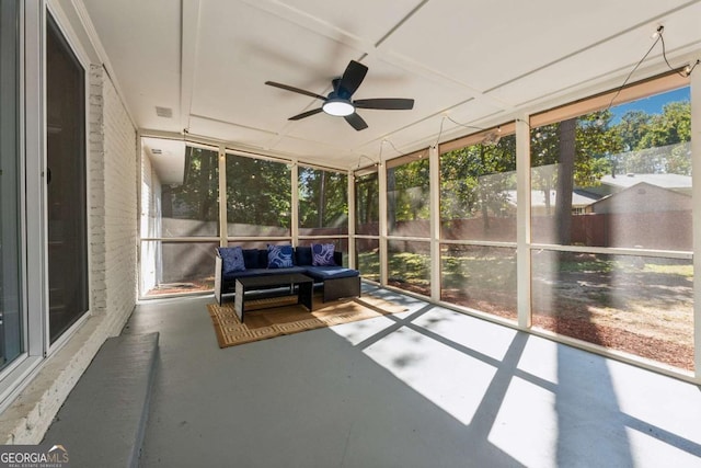 unfurnished sunroom featuring ceiling fan