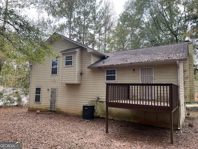 rear view of property with a wooden deck and central AC unit