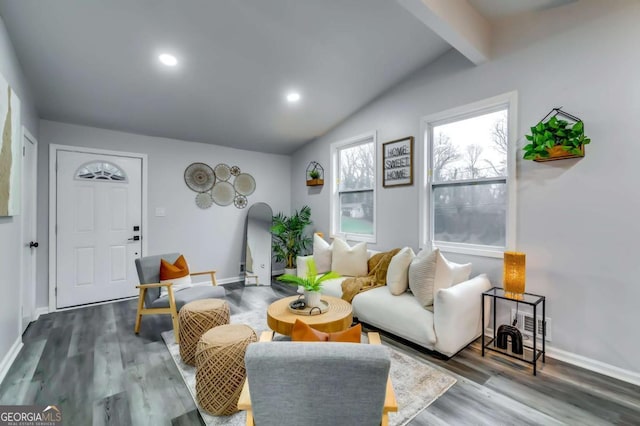 living room featuring lofted ceiling with beams and hardwood / wood-style floors