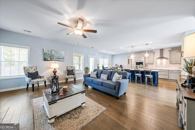 living room featuring hardwood / wood-style flooring and ceiling fan