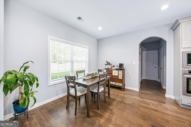 dining space with dark wood-type flooring