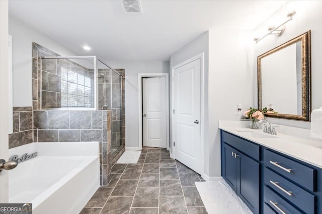 bathroom featuring vanity and shower with separate bathtub