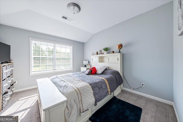 bedroom with lofted ceiling and light carpet