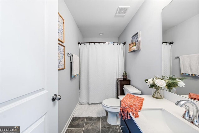 bathroom featuring vanity, curtained shower, and toilet