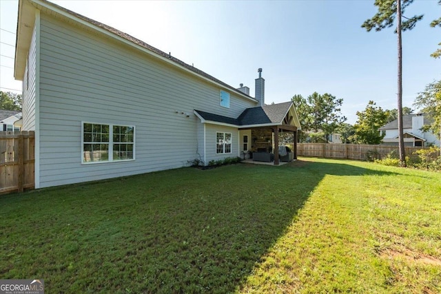 back of house with a lawn