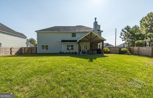 back of house with a yard