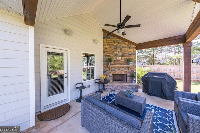 view of patio / terrace featuring ceiling fan, grilling area, and an outdoor living space with a fireplace