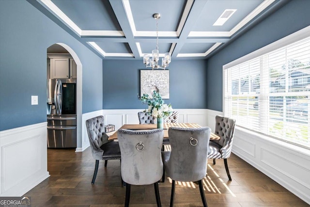 dining area with dark wood-type flooring, coffered ceiling, beamed ceiling, ornamental molding, and a chandelier