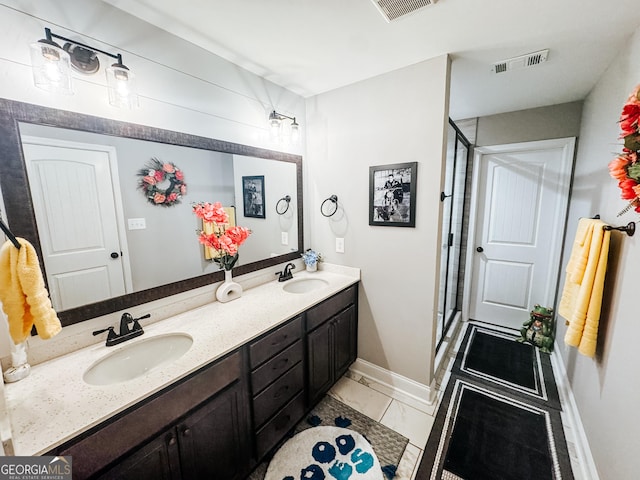 bathroom with vanity, tile patterned flooring, and walk in shower