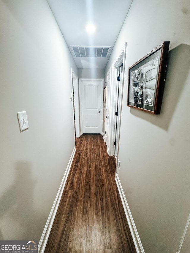 hallway with dark hardwood / wood-style flooring