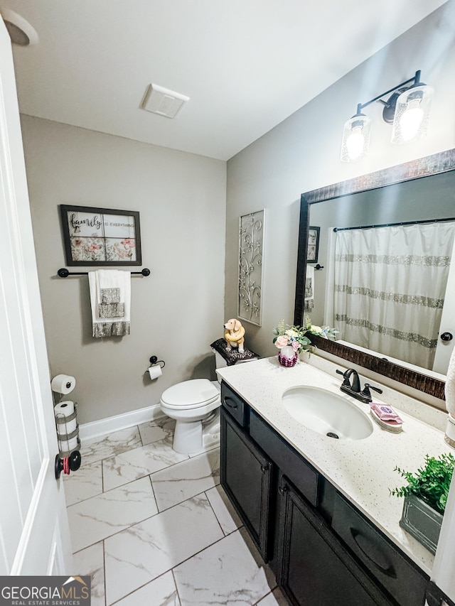 bathroom with vanity and toilet